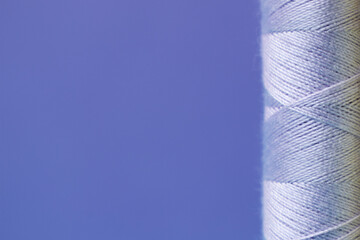 Violet pastel colors sewing threads on a violet background, multicolored spools, copy space for...