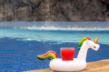 summer vacation leisure time.kid or woman on seashore relaxing.child playing with sands toys smiling,lies on belly.girl with back drinking blue lagoon cocktail.sea water waves enjoy trip.unicorn pool