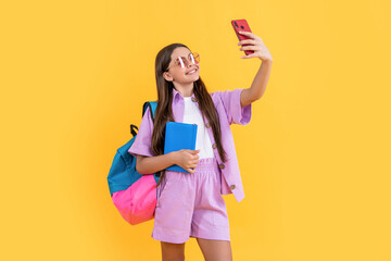 selfie teen school girl in studio. selfie teen school girl on background.