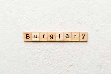 burglary word written on wood block. burglary text on table, concept
