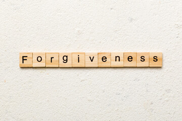 forgiveness word written on wood block. forgiveness text on table, concept