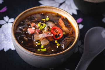 Seaweed Korean soup Miyeokguk or Miyeok guk  recipe, hot healthy soup  with beef and Wakame seaweeds. Ethnic background with flowers. Reptiles of traditional Korean food. Algae - Food Trend 2023
