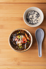 Seaweed Korean soup Miyeokguk or Miyeok guk  recipe, hot healthy soup  with beef and Wakame seaweeds. Ethnic bamboo background. Reptiles of traditional Korean food. Algae - Food Trend 2023