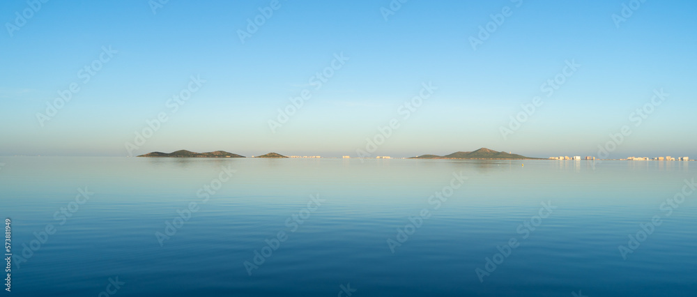 Wall mural Landscape of two islands in a small sea with very calm water. Isla de la Perdiguera and Isla del Báron in the Mar Menor, Murcia, Spain.