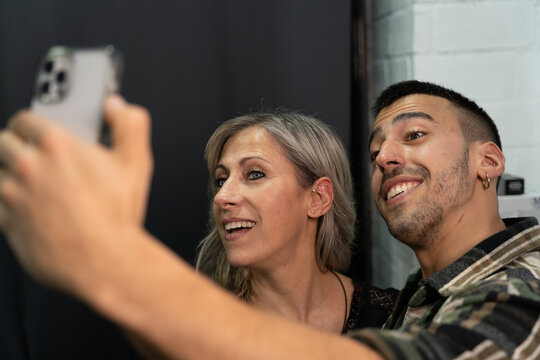 Mother and son taking a selfie with a mobile device smiling at the camera. Concept photos for social networks. Real people