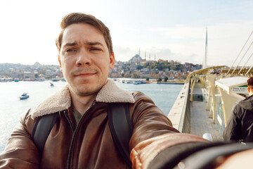 Portrait of a tourist man taking a selfie picture in Istanbul.