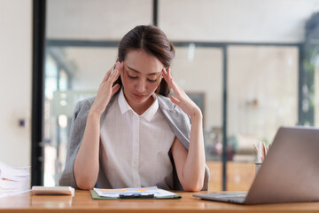 Obraz premium Tired business woman in stress works with many paperwork document. migraine attack. Freelance, work from home.