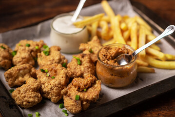 Cauliflower wings food. Cauliflower pieces and french fries with vegan sauces. Vegetarian food.