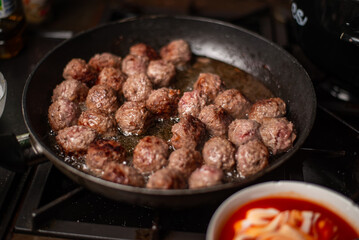 Homemade beef meatballs cooked with tomato and sour cream sauce.
