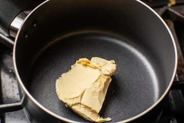 Melt the butter in a saucepan. The initial stage of preparing the sauce
