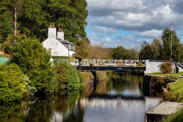 Fototapeta na wymiar Rotating bridge and bridge keeper's house on Crinan Canal, Argyll, Scotland, United Kingdom