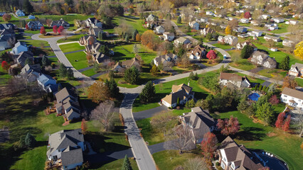Colorful low-density residential living suburban neighborhood with autumn leaves and grassy yards landscaping in Rochester, Upstate New York, USA