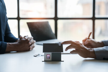 Young Asian home sales agents, insurance agents, and real estate agents offer young Asian entrepreneurs information on price conditions when signing a contract to buy rent house in the office.