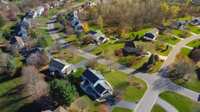 Low density single family residential houses with grassy yards landscaping in established development neighborhood in Rochester, Upstate New York, USA