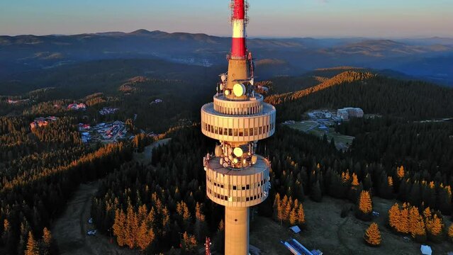 Tower Snezhana on peak of Snezhana covered with spruce forests in Rhodope mountains