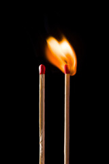 Lighting matches at the moment when it explodes. Burning match on black background. 