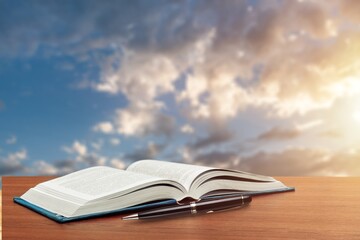 Reading Book with office Pen on desk