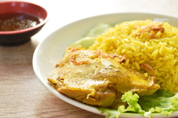 biryani rice cooked with chicken in curry on plate dipping spicy chili sauce
