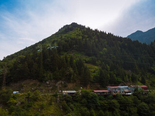 Aerial view Inguri reservoir lake in Upper Svaneti region, Georgia. Summer day, Emerland water. Communication tower, metal structure. Power lines, wires and energy in hard-to-reach places.