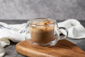 Coffee with milk. Prepared coffee in a double wall glass. close up