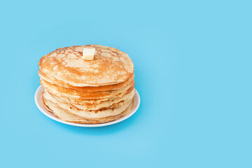 Staple of yeast fluffy pancakes with butter. Spring holiday Traditional Russian Shrovetide Maslenitsa week or pancake tuesday holiday. american crepes isolated on white gray background. side view