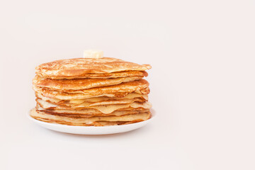 Staple of yeast fluffy pancakes with butter. Spring holiday Traditional Russian Shrovetide Maslenitsa week or pancake tuesday holiday. american crepes isolated on white gray background. side view