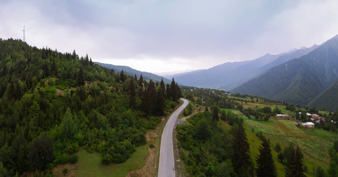 Summer mountain valley, beautifull road way to Mestia. Tsalanari, Hebudi, Georgia. Nature and car travel concept. Asphalt road among the mountains. Wide panorama. Aerial view.