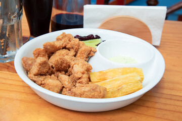 Chicharrón de pota pescado fish sticks Sea food ceviche Assorted food plates Peru traditional comfort food buffet table