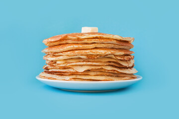 Staple of yeast fluffy pancakes with butter. Spring holiday Traditional Russian Shrovetide Maslenitsa week or pancake tuesday holiday. american crepes isolated on white gray background. side view