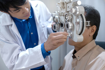 Optometrist uses ophthalmological diagnostic equipment to test the vision of an elderly man, Professional medical machine, diagnostic ophthalmology equipment, selective focus