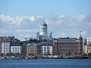Fototapeta na wymiar Helsinki Cathedral, sail ships and buildings with partly cloudy sky