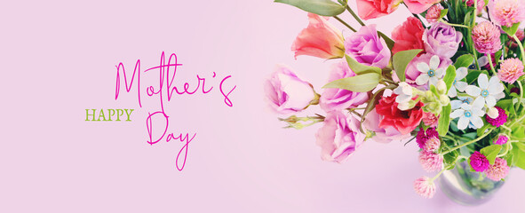 mother's day concept with pink and purple flowers over pastel background