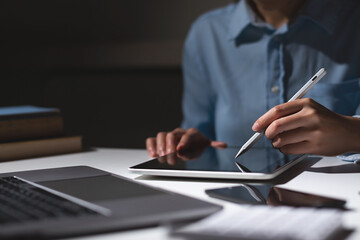 Close up of student hand using electronic pen with tablet. education e-learning concept.