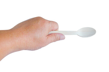 Hand holding a wood spoon on white background.