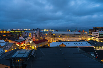 A night time photograph of Rykjavik, Iceland including the harbor - obrazy, fototapety, plakaty