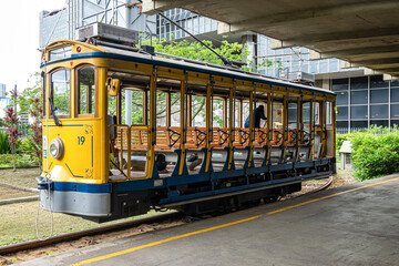 The famous old tram Bonde de Santa Teresa in Rio de Janeiro, Brazil. Yellow tram traveling through Rio de Janeiro - obrazy, fototapety, plakaty