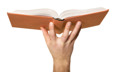 education and book concept - close up hand holding open book with magic lights