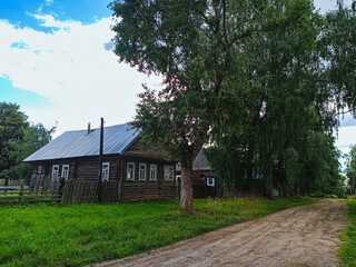 Old wooden house in the village on a sunny summer day
