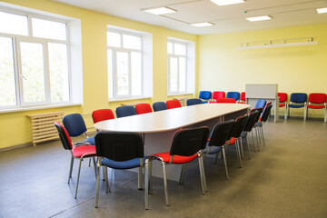 Colorful chairs around a large table in the classroom
