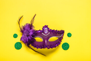 Mardi gras lettering. Congratulation card with violet mask on yellow background Top view 2023 Mardi Gras Parade Schedule Mockup Copy space