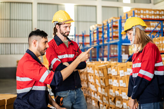 Warehouse manager and foreman working serious in a large warehouse. Logistic business.