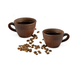 clay cups with coffee and roasted coffee beans isolated on white background.