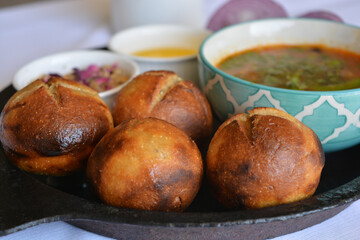 Close up of roasted dal baati churma-a traditional north Indian cuisine in a cast iron plate