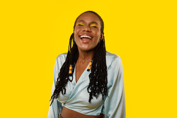 Cheerful African American Lady Laughing Out Loud Over Yellow Background