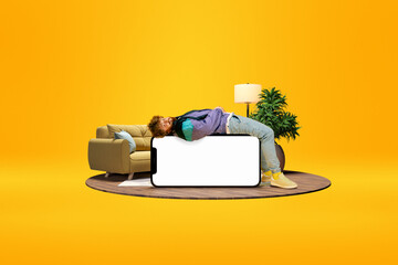 Relaxed young man lying on huge 3D model of mobile phone with empty screen for text, ad over bright...