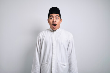 Asian muslim man shocked gesture can not believe of what he sees.