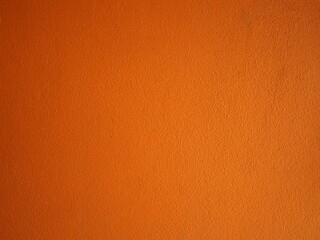 Empty orange concrete  wall background, Vintage style for wallpaper, background and backdrop. Halloween background empty. Orange autumn hues background vivid light top
