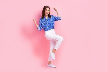 Full length photo of lucky funky lady wear print shirt rising fists empty space isolated pink color...