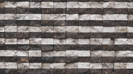 Several rows of a rough textured concrete block wall as background, wallpaper. Stone wall background , random black granite stone wall