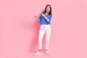 Full length photo of adorable excited lady wear print shirt showing looking empty space isolated pink color background